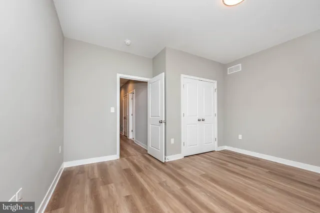 a view of an empty room and wooden floor