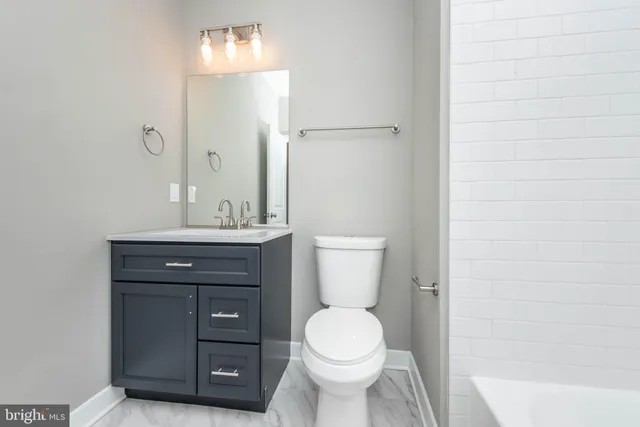 a bathroom with a sink a toilet and vanity
