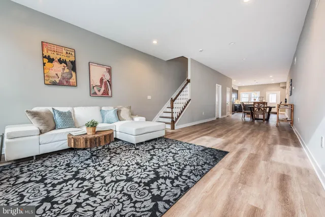 a living room with a couch and a wooden floor