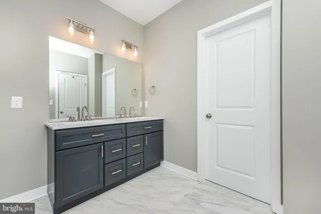 a bathroom with a double vanity sink and a mirror