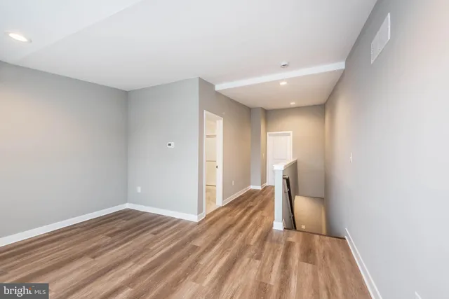 a view of a room with wooden floor and bathroom