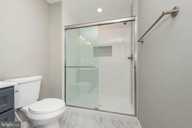 a bathroom with a shower and a toilet