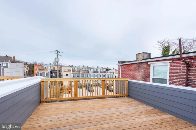 a view of roof deck with two chairs and wooden floor