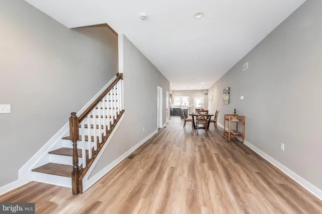 a view of dining room and hall with wooden floor