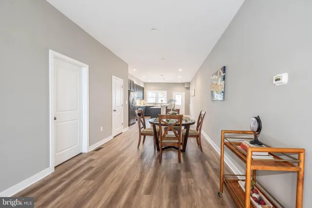 a view of a dining room with furniture and wooden floor