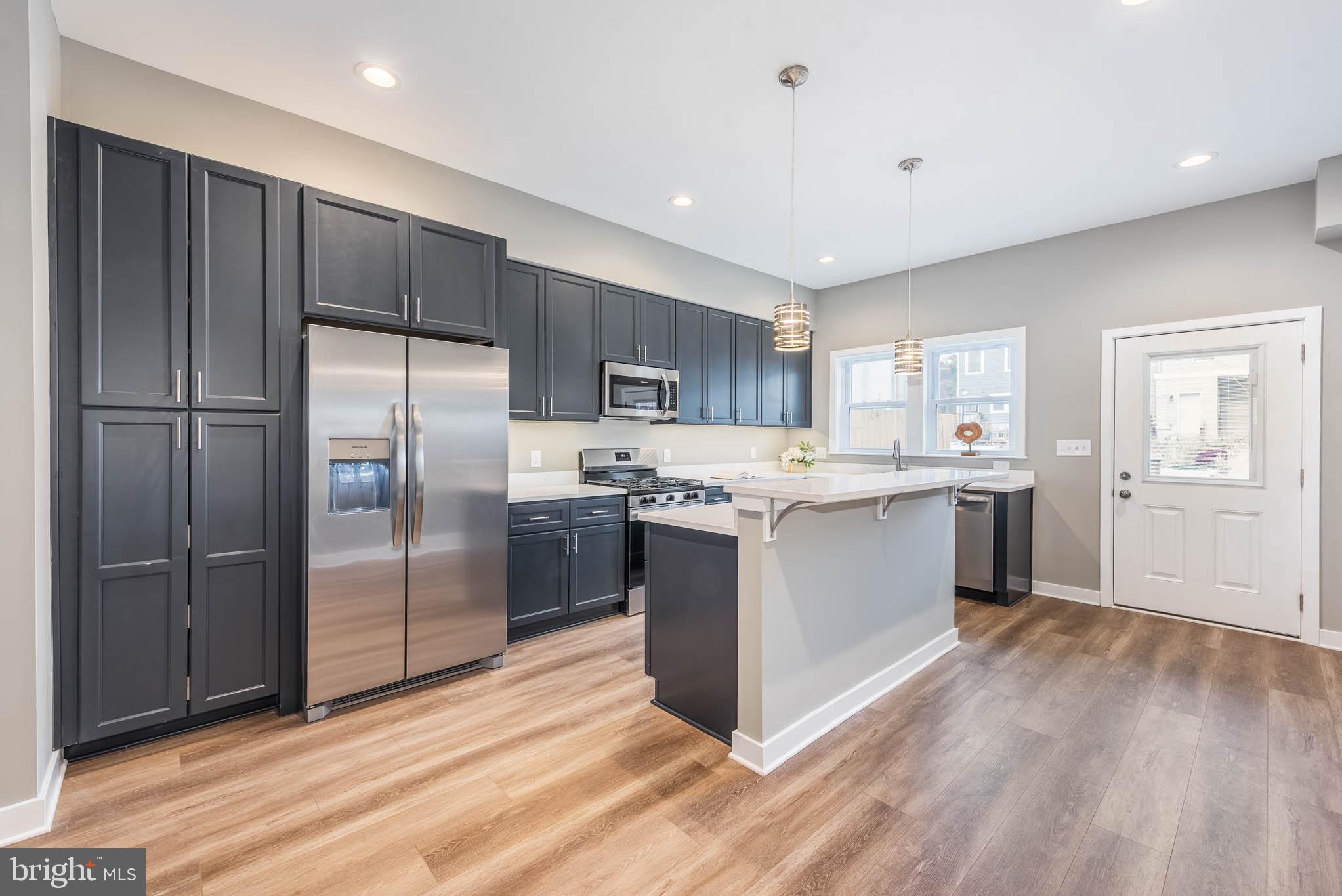 848 Edmondson Avenue Baltimore, MD 21201 - Photo 9 of 41 a kitchen with a refrigerator sink and cabinets