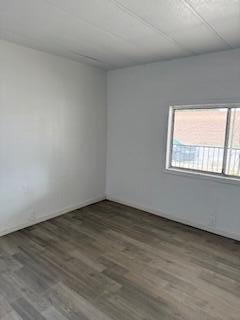 681 South Market Road Earlimart, CA 93219 - Photo 7 of 13 a view of an empty room with wooden floor and a window