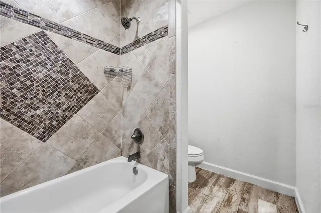 a bathroom with a shower and a bathtub