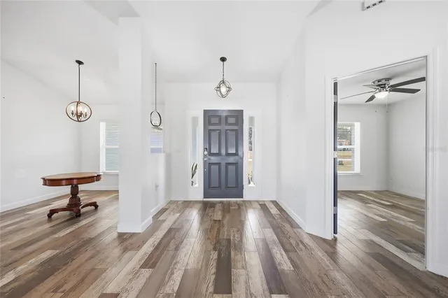 a view of a hallway view with staircase and kitchen view
