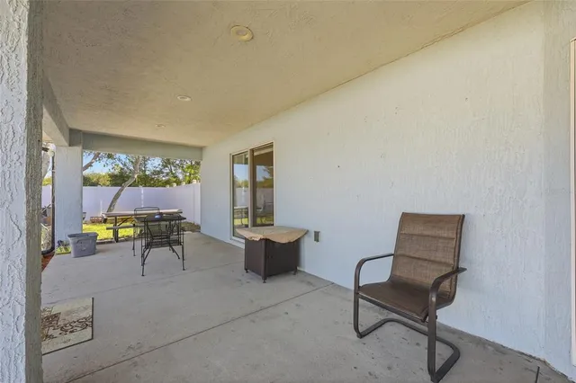 a swimming pool with outdoor seating and yard