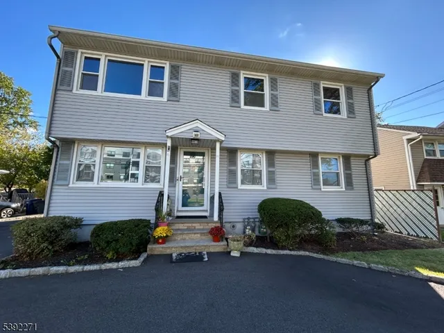 a front view of a house with a yard and outdoor seating