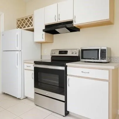 a kitchen with stainless steel appliances a stove a microwave and a refrigerator