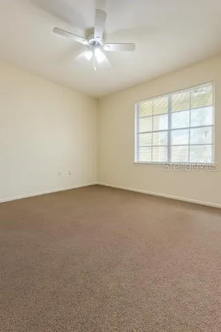 an empty room with a empty space and windows