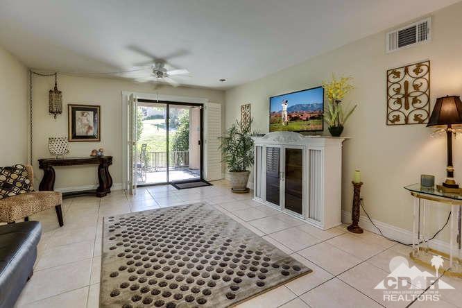 72399 Ridgecrest Lane Palm Desert, CA 92260 - Photo 13 of 34 a living room with furniture a flat screen tv and a fireplace