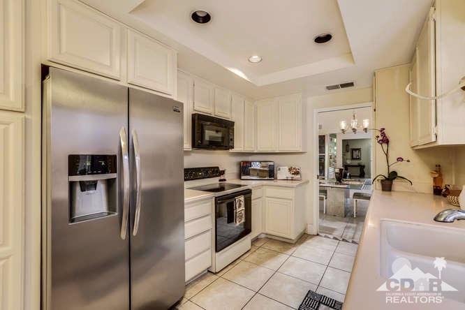 72399 Ridgecrest Lane Palm Desert, CA 92260 - Photo 17 of 34 a kitchen with stainless steel appliances granite countertop a refrigerator sink and stove