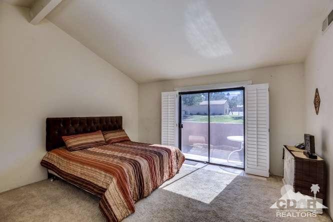 72399 Ridgecrest Lane Palm Desert, CA 92260 - Photo 23 of 34 a bedroom with a bed and a dresser next to a window