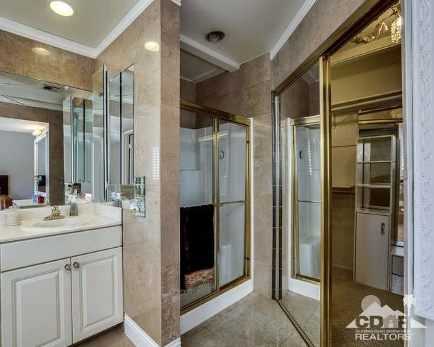 72399 Ridgecrest Lane Palm Desert, CA 92260 - Photo 26 of 34 a bathroom with a double vanity sink and mirror