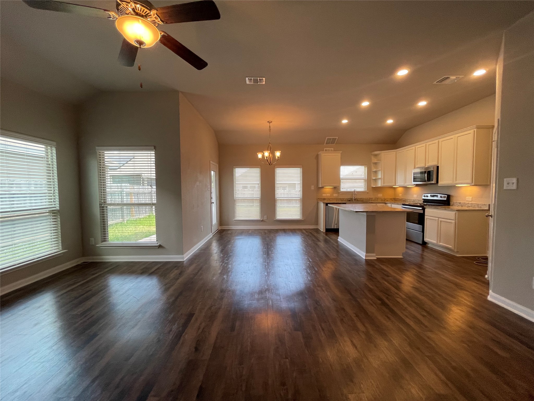 8113 Northgate Loop Temple, TX 76502 - Photo 4 of 35 Open-concept living space featuring rich wood-finish flooring, vaulted ceilings, and a contemporary ceiling fan