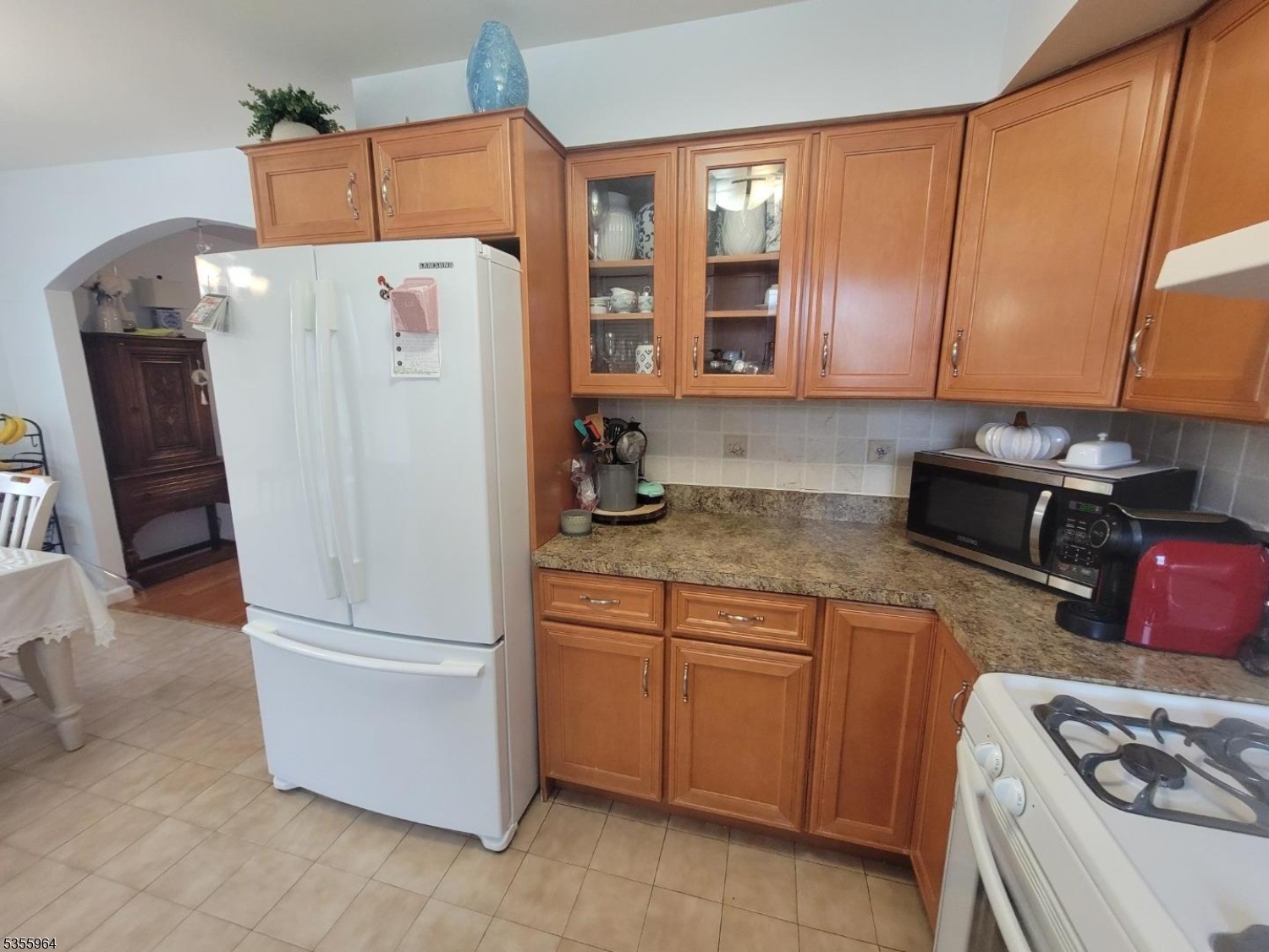 63 Rome Street Newark, NJ 07105 - Photo 6 of 11 a white refrigerator freezer sitting in a kitchen