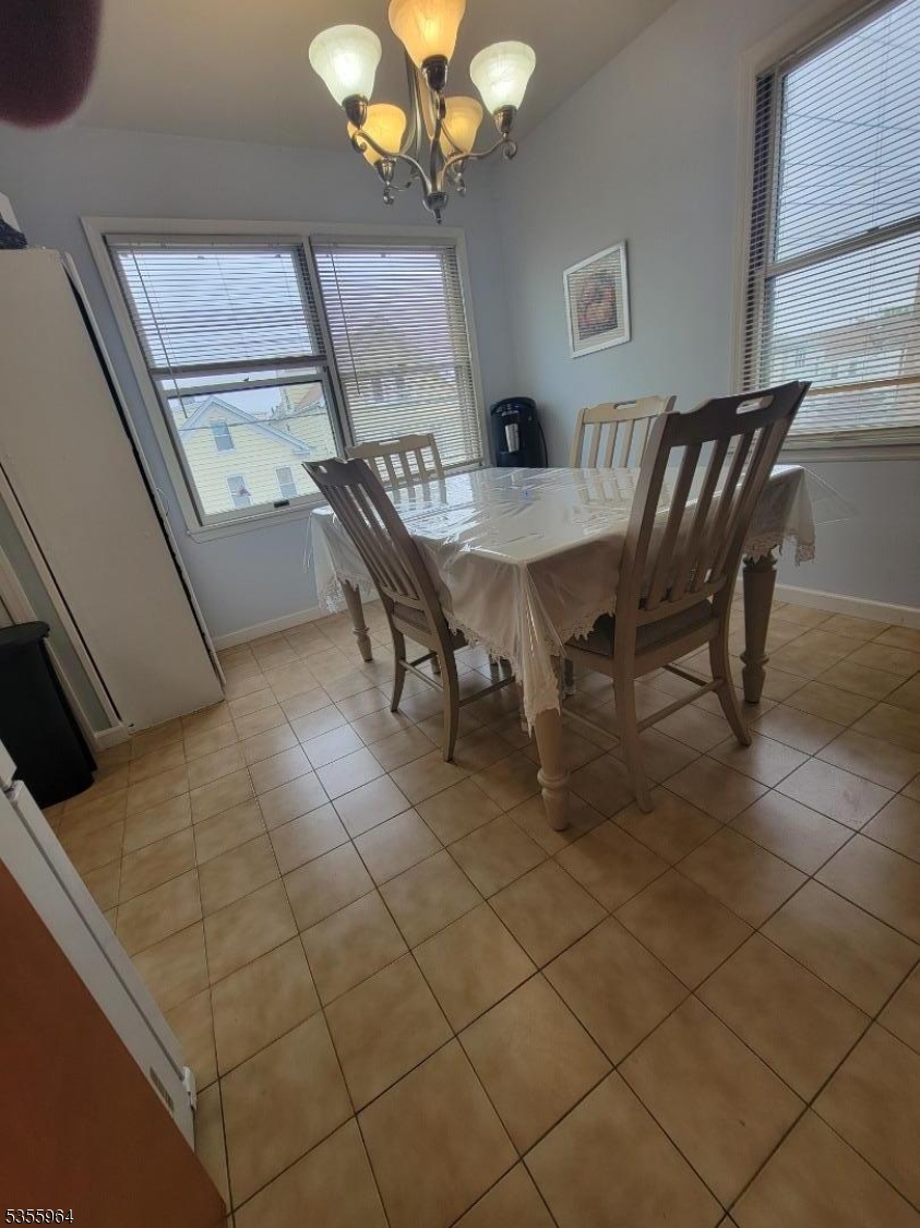 63 Rome Street Newark, NJ 07105 - Photo 7 of 11 a dining room with furniture and a chandelier