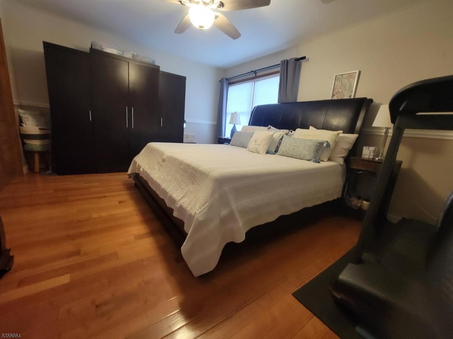 63 Rome Street Newark, NJ 07105 - Photo 8 of 11 a spacious bedroom with a bed and a chandelier