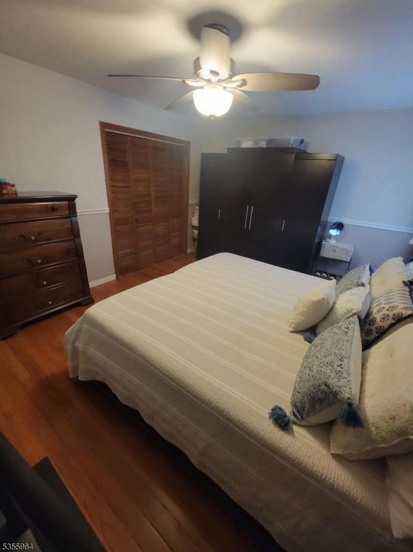 63 Rome Street Newark, NJ 07105 - Photo 9 of 11 a bedroom with a bed and a chandelier
