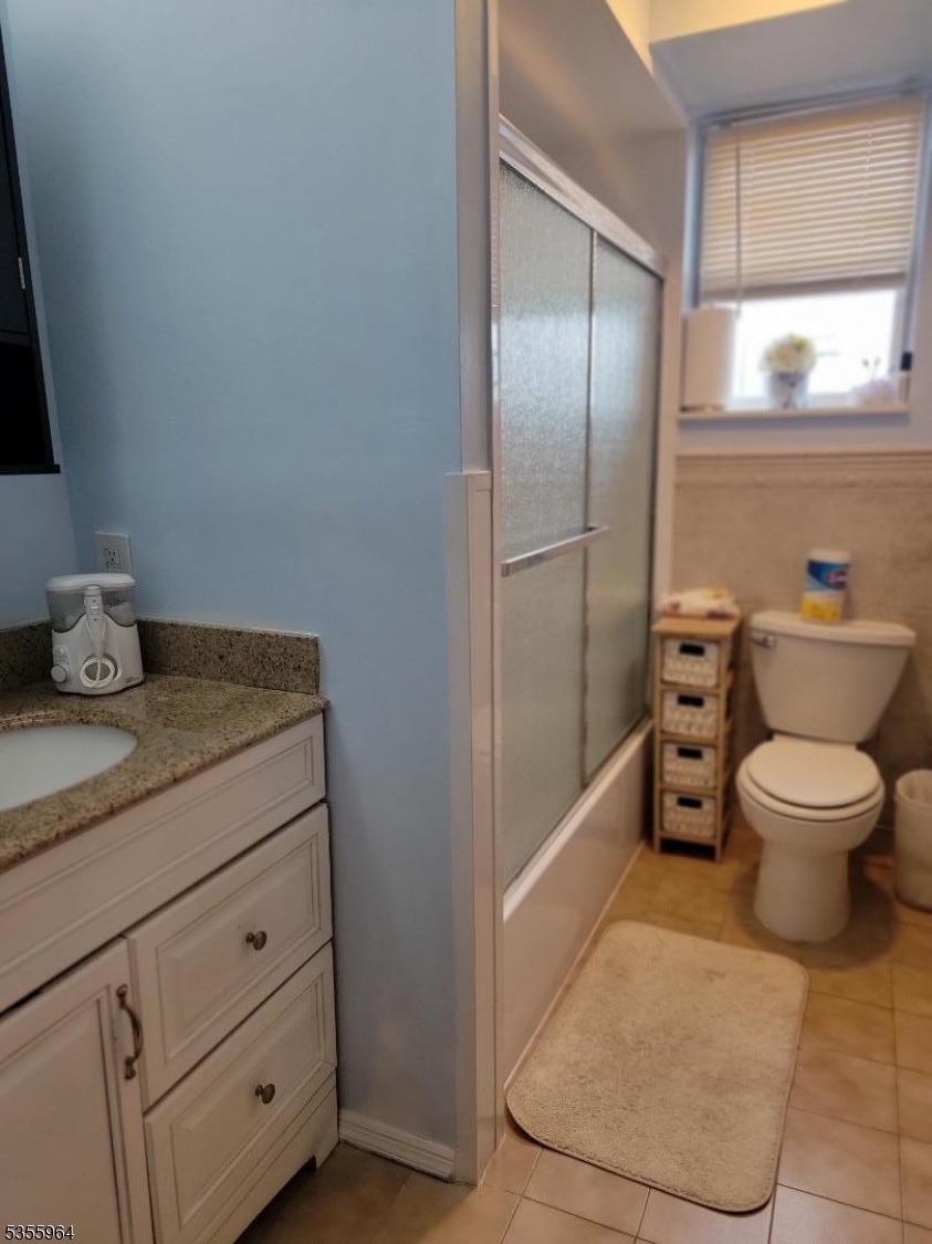 63 Rome Street Newark, NJ 07105 - Photo 10 of 11 a bathroom with a granite countertop toilet and a sink