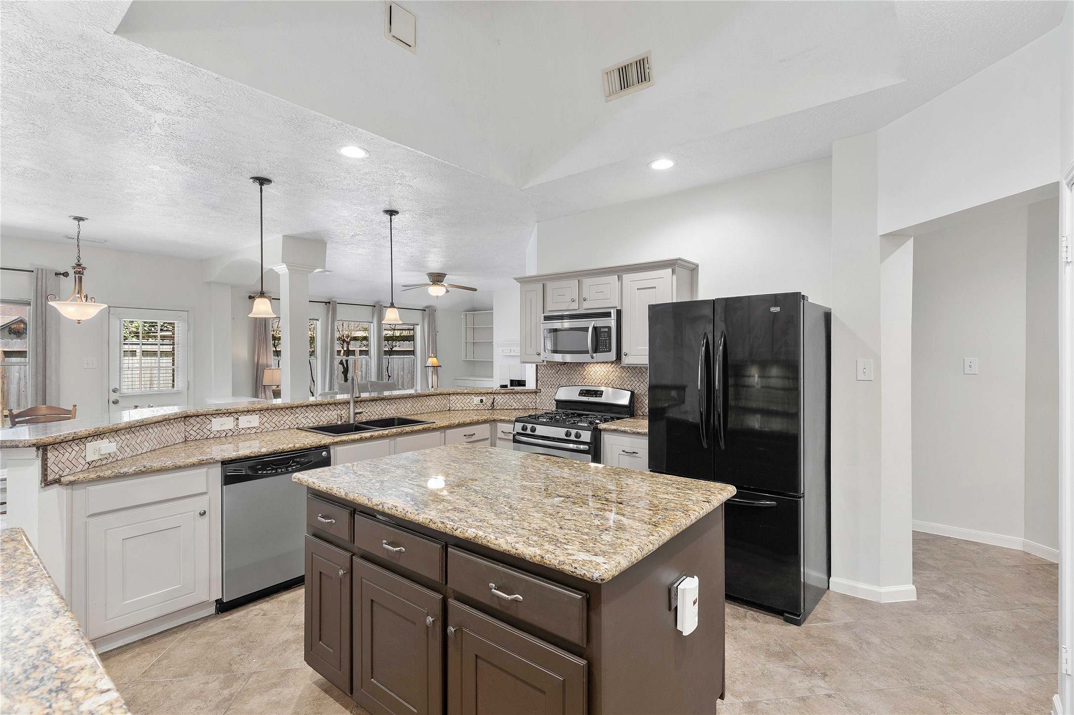 1707 Moston Drive Spring, TX 77386 - Photo 15 of 41 a kitchen with stainless steel appliances granite countertop a sink stove and refrigerator