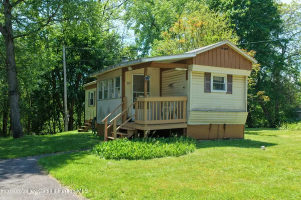 a view of a house with a backyard and deck