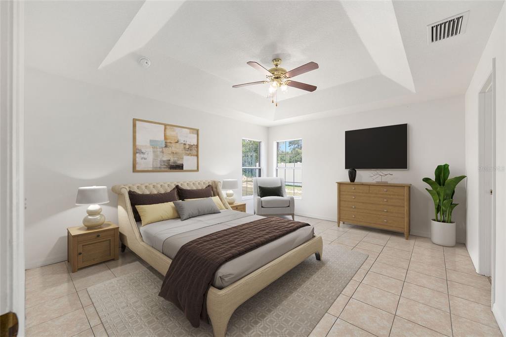 15434 Southwest 23rd Court Road Ocala, FL 34473 - Photo 22 of 41 a bedroom with a bed and a flat screen tv