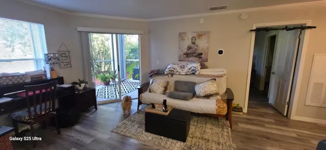 a living room with furniture and wooden floor