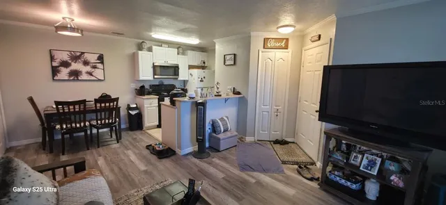 a view of a livingroom with furniture and a flat screen tv