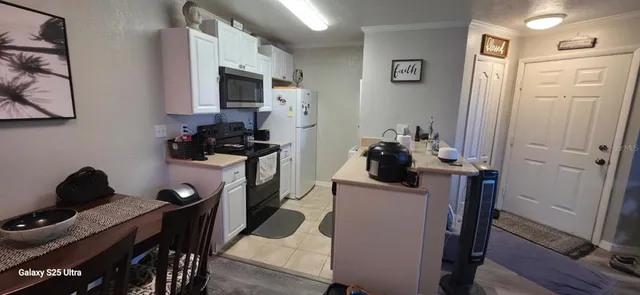 a view of a workspace with furniture and wooden floor
