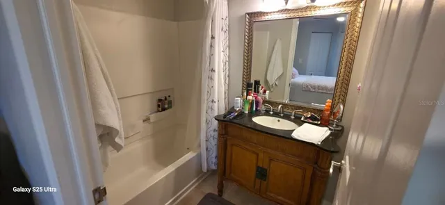 a bathroom with a sink a mirror and a shower