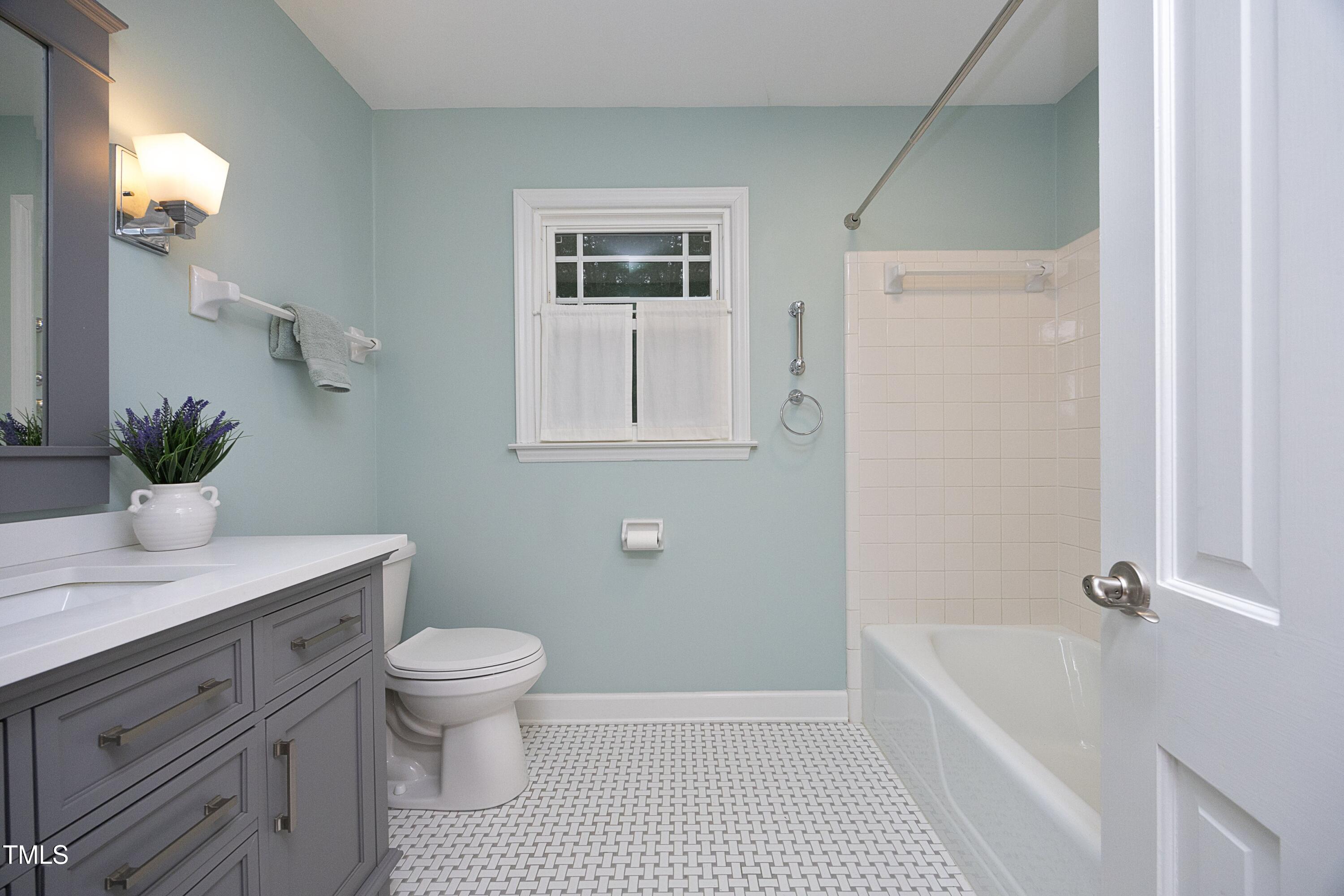 4616 Oak Park Road Raleigh, NC 27612 - Photo 33 of 63 Full bath on 2nd floor with tub/shower combo, ceramic floor & marble vanity