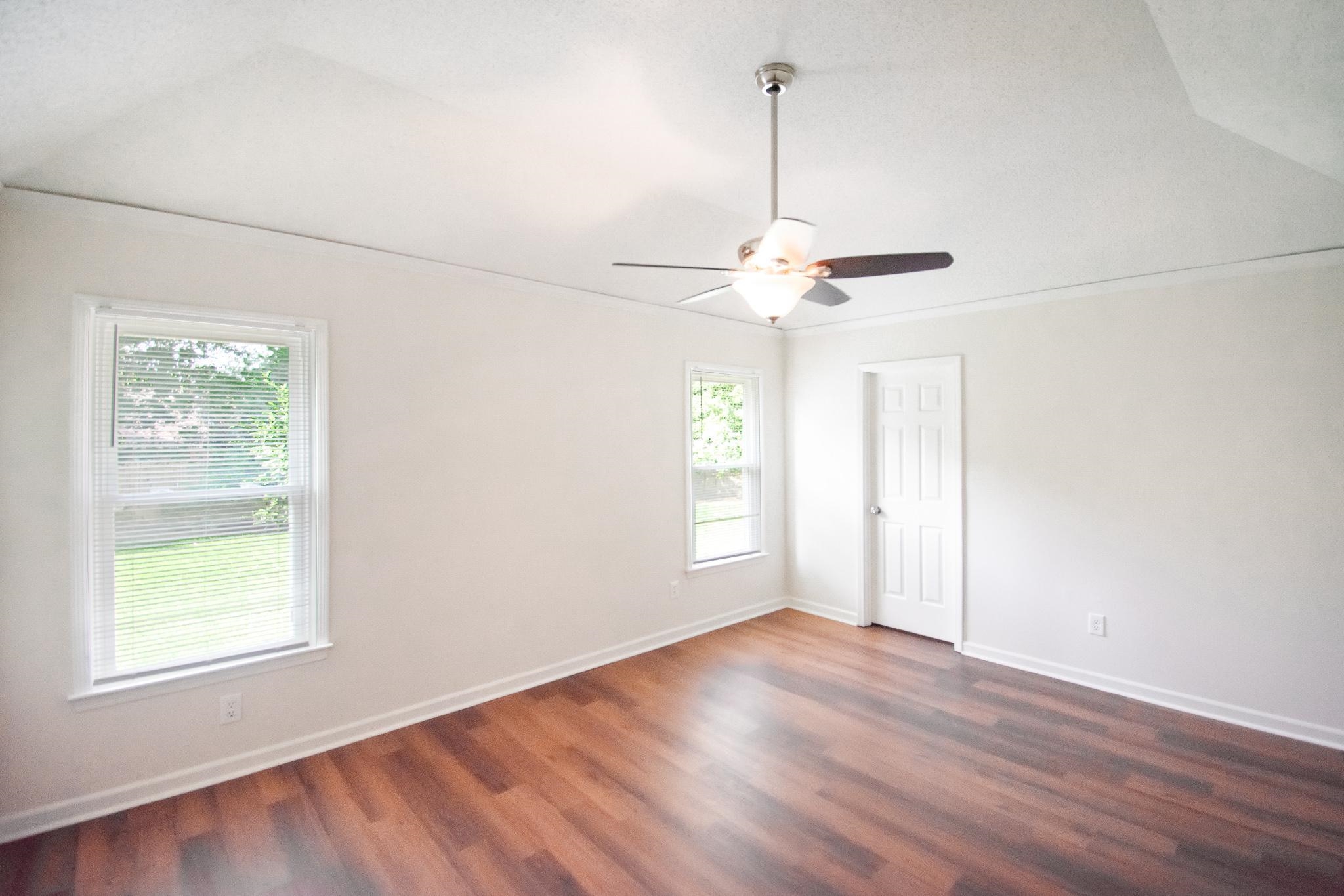 6756 Martha's Point Memphis, TN 38141 - Photo 11 of 15 a view of an empty room with wooden floor and a window