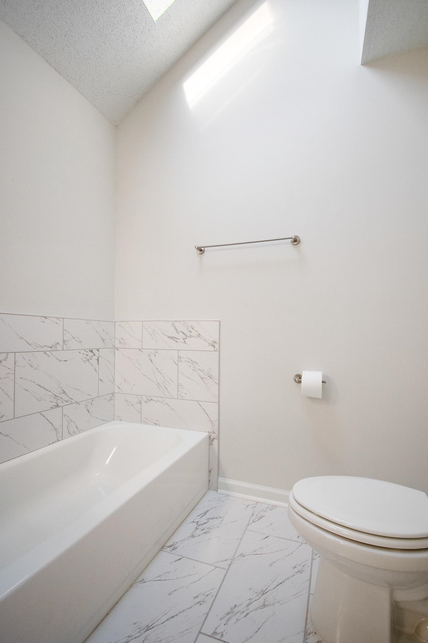6756 Martha's Point Memphis, TN 38141 - Photo 13 of 15 a white bath tub sitting next to a white toilet
