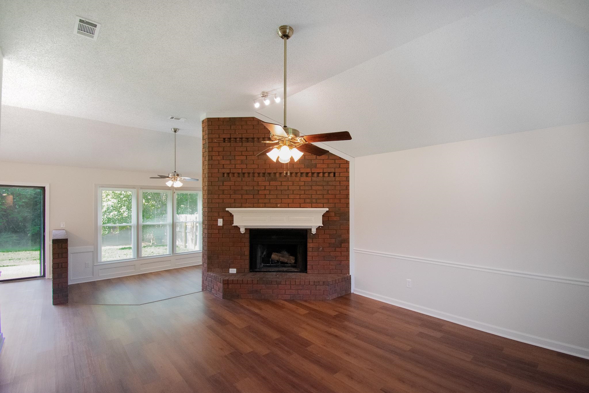 6756 Martha's Point Memphis, TN 38141 - Photo 2 of 15 a view of a livingroom with wooden floor a fireplace and windows