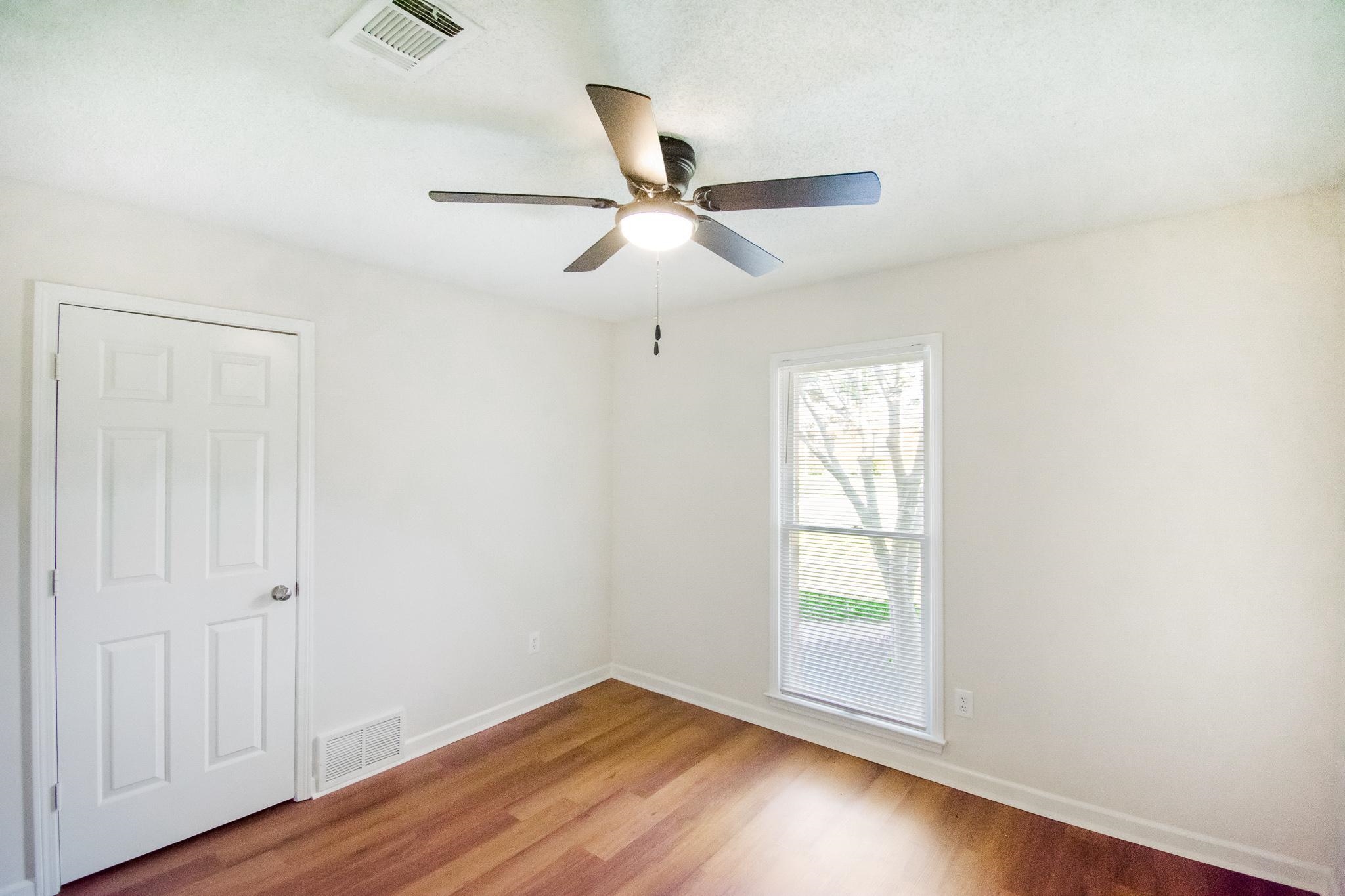 6756 Martha's Point Memphis, TN 38141 - Photo 8 of 15 an empty room with wooden floor fan and windows