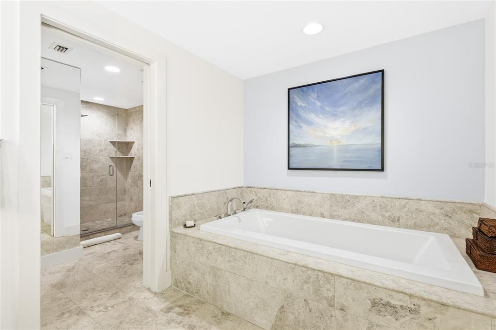 455 Longboat Club Road, Unit 408 Longboat Key, FL 34228 - Photo 17 of 58 a bathroom with a bathtub and a shower