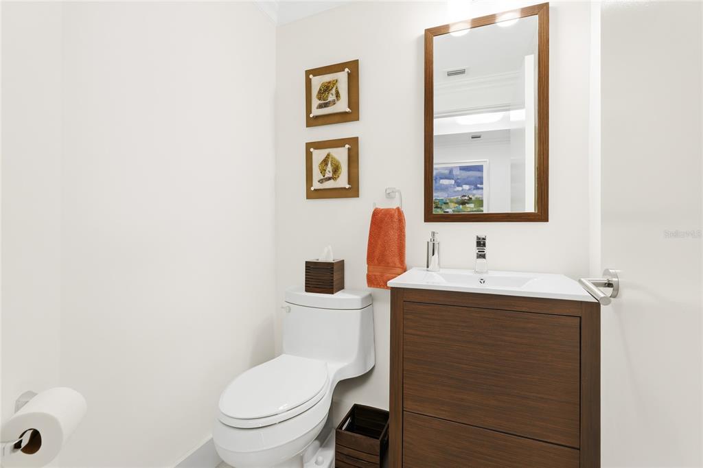 455 Longboat Club Road, Unit 408 Longboat Key, FL 34228 - Photo 25 of 58 a bathroom with a toilet a sink and mirror