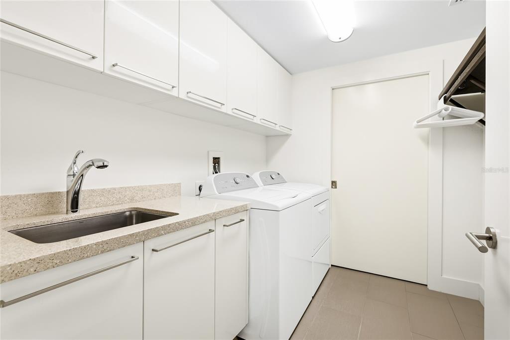 455 Longboat Club Road, Unit 408 Longboat Key, FL 34228 - Photo 26 of 58 a kitchen with a sink and cabinets