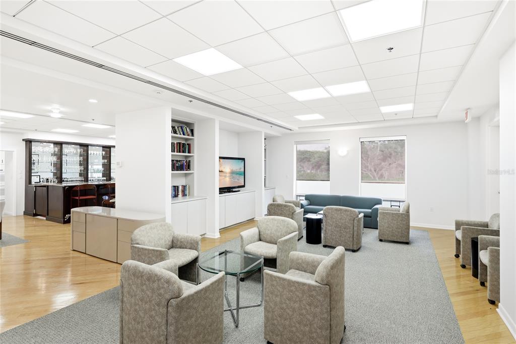 455 Longboat Club Road, Unit 408 Longboat Key, FL 34228 - Photo 49 of 58 a living room with fireplace furniture and a table