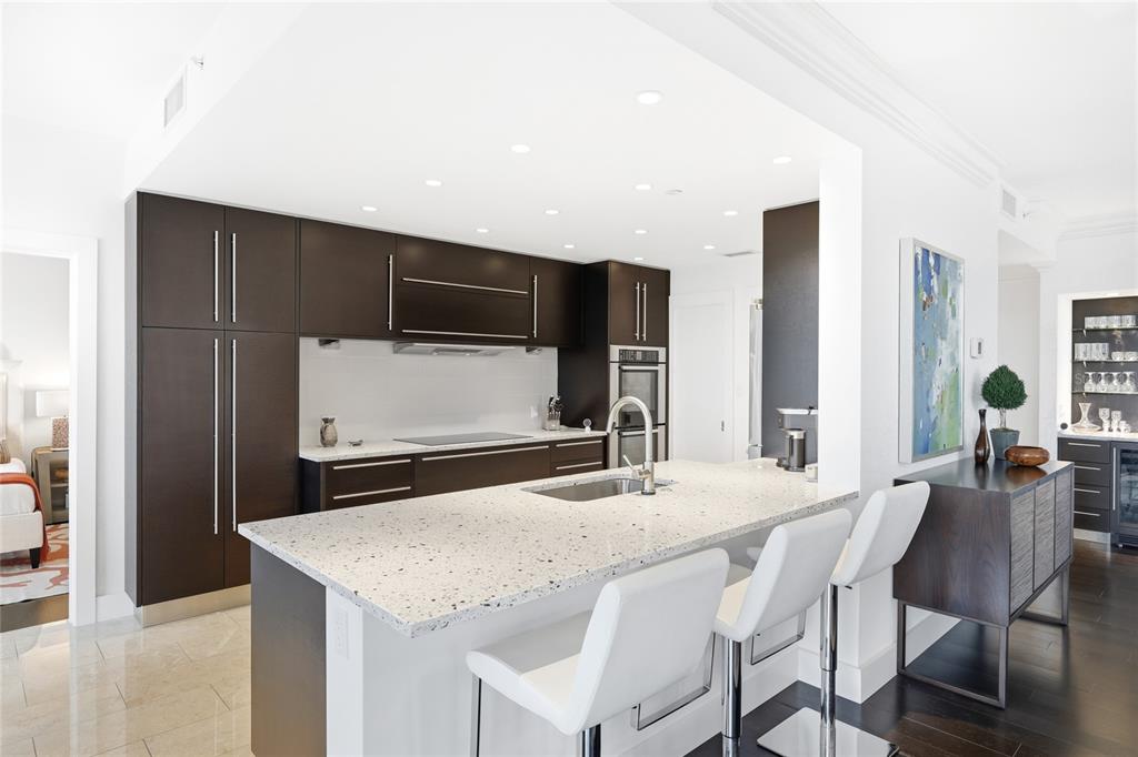 455 Longboat Club Road, Unit 408 Longboat Key, FL 34228 - Photo 5 of 58 a kitchen with stainless steel appliances kitchen island granite countertop a refrigerator and a stove top oven