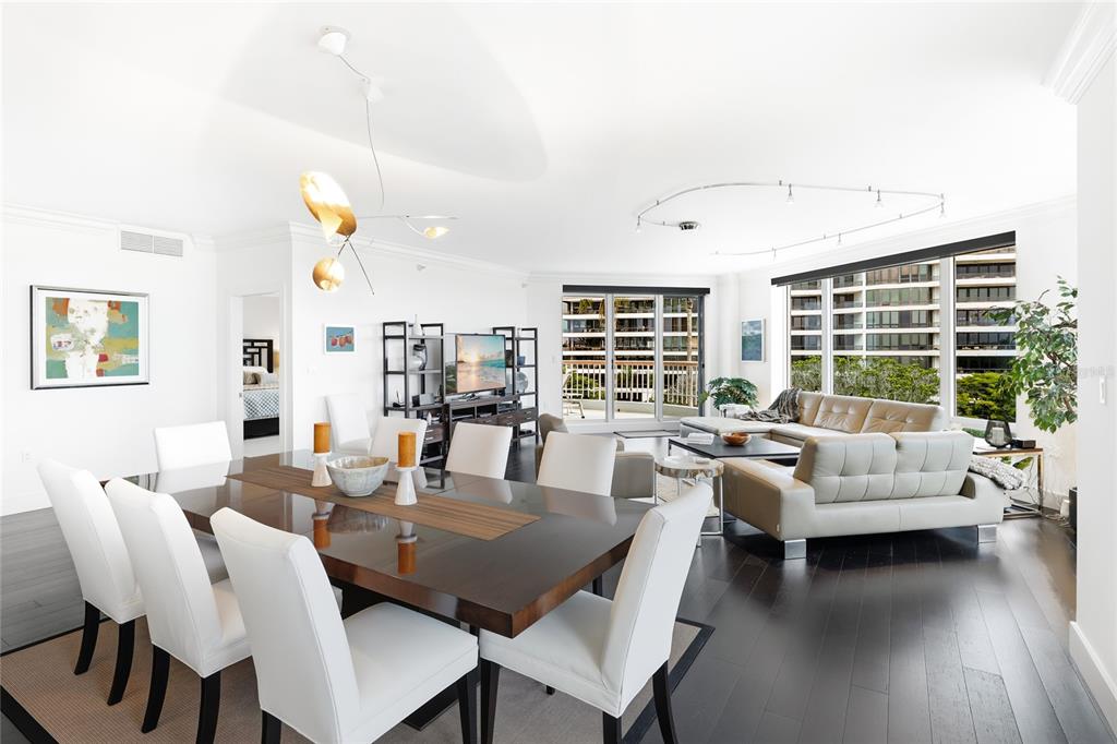 455 Longboat Club Road, Unit 408 Longboat Key, FL 34228 - Photo 8 of 58 a view of a dining room with furniture and wooden floor
