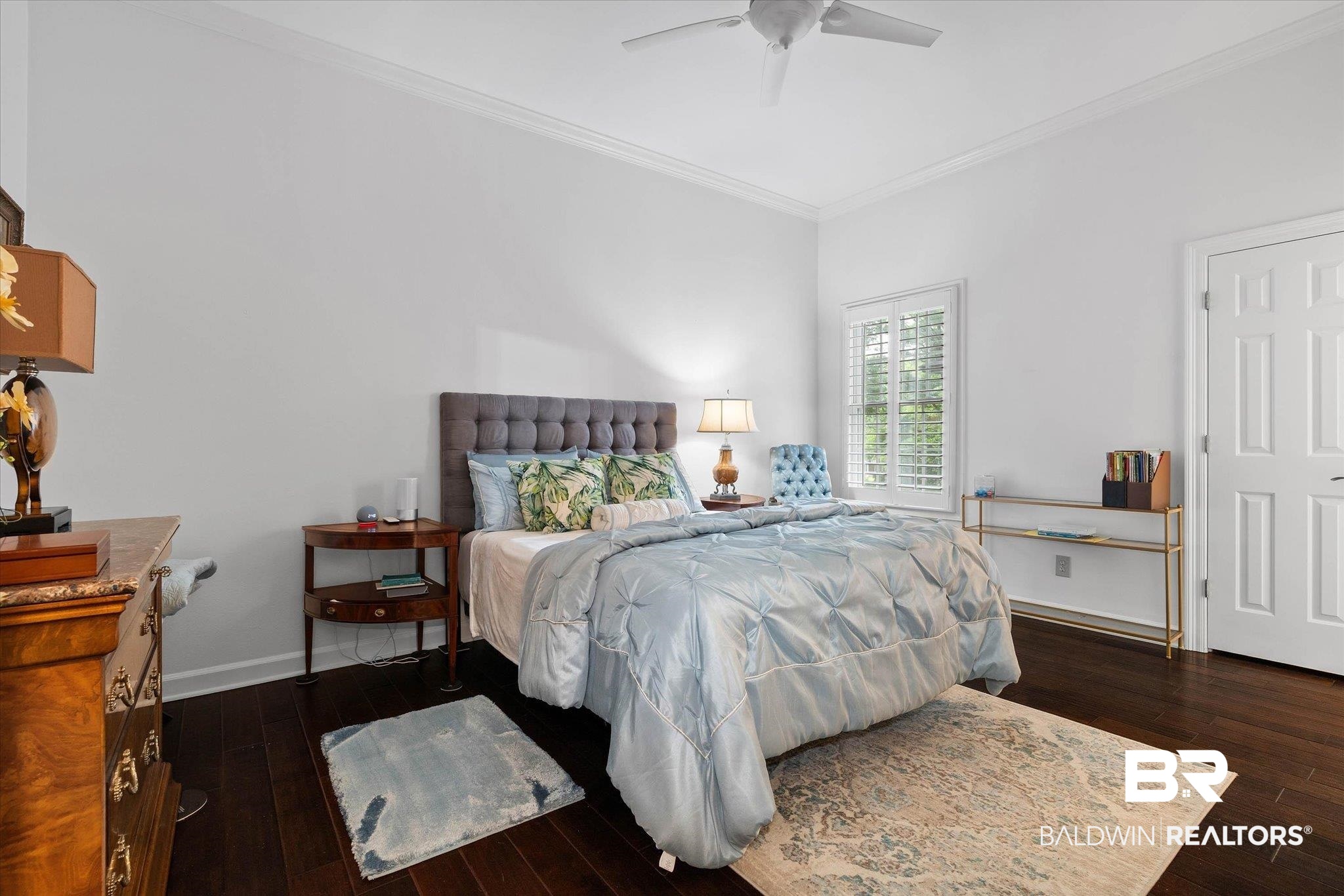 136 Old Mill Road Fairhope, AL 36532 - Photo 24 of 36 Bedroom featuring rich wood-finish flooring, crisp white walls, and elegant crown molding