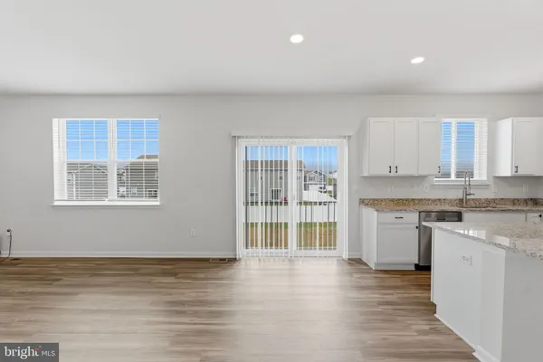 a kitchen with a sink a stove a refrigerator and cabinets