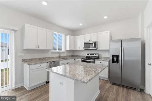 a kitchen with sink and cabinets
