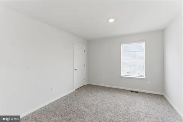 a view of room with stairs and wooden floor