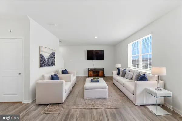 a view of kitchen with wooden floor and windows
